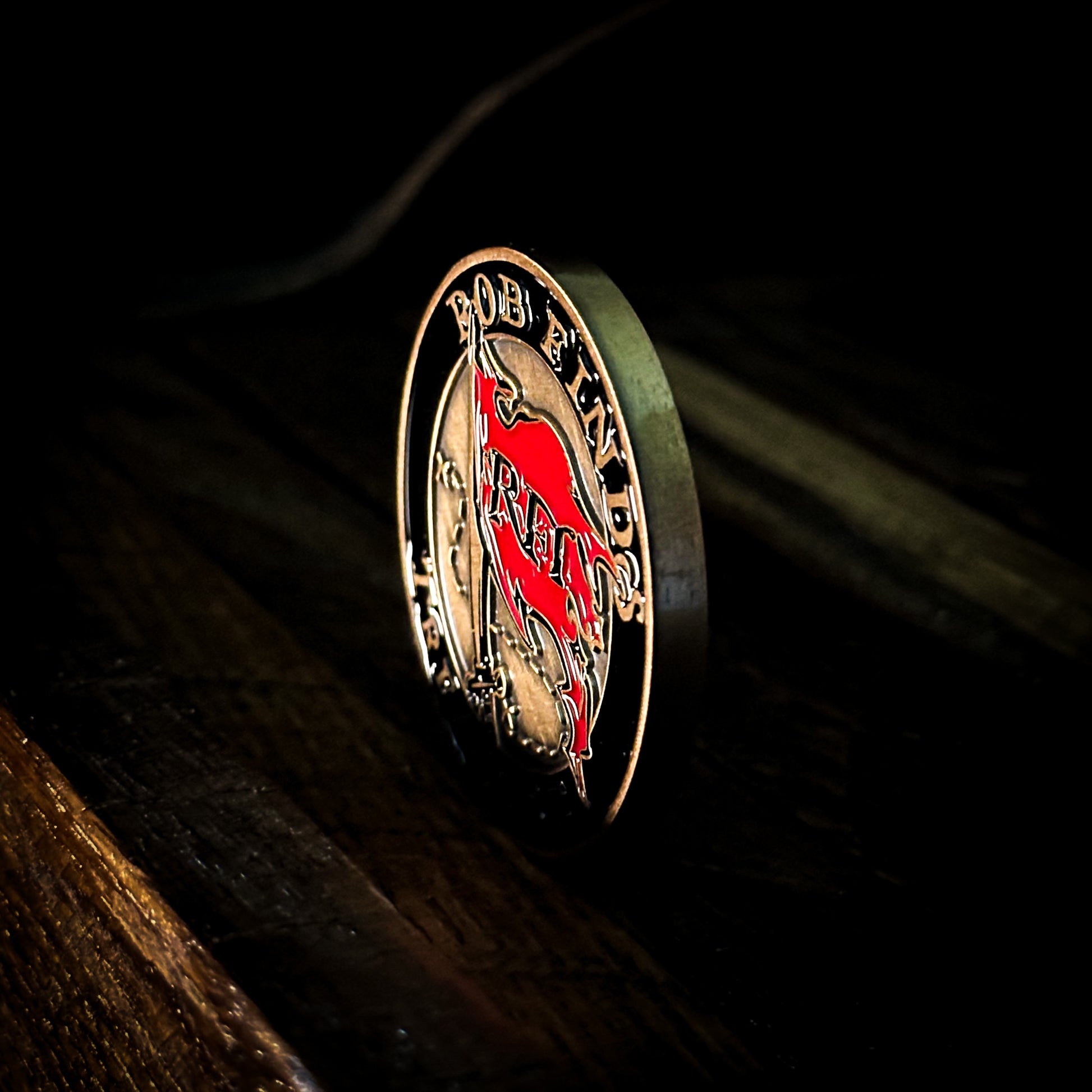 Rob Finds Treasure Bronze Challenge Coin with background, side edge view